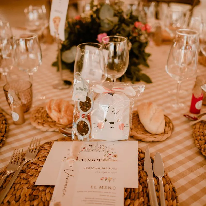 Detalles personalizados para bautizo colocados sobre una mesa